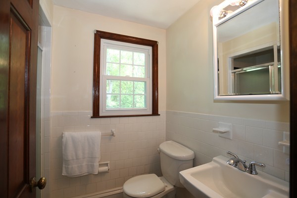 88 Warren Road Sudbury, MA 01776 - Photo 11 of 16 a bathroom with a toilet sink and mirror