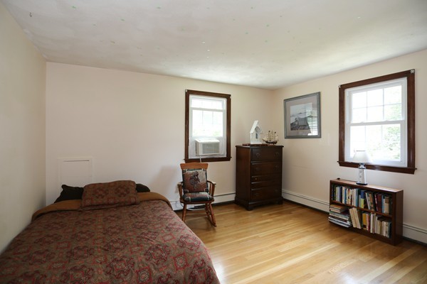 88 Warren Road Sudbury, MA 01776 - Photo 12 of 16 a bedroom with a bed and wooden floor