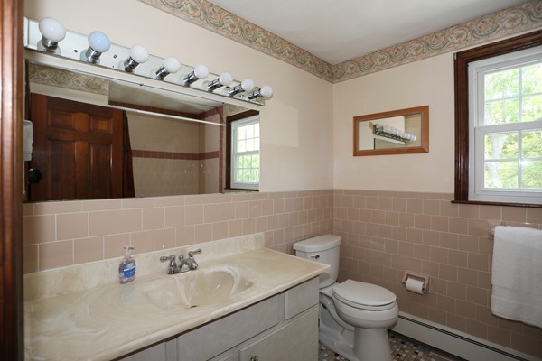 88 Warren Road Sudbury, MA 01776 - Photo 13 of 16 a bathroom with a sink mirror vanity and toilet