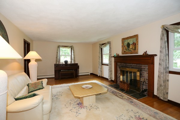 88 Warren Road Sudbury, MA 01776 - Photo 4 of 16 a living room with furniture and a fireplace