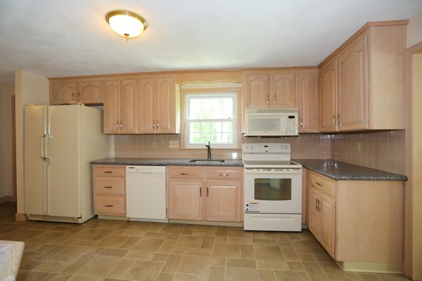 88 Warren Road Sudbury, MA 01776 - Photo 7 of 16 a kitchen with white cabinets and white appliances