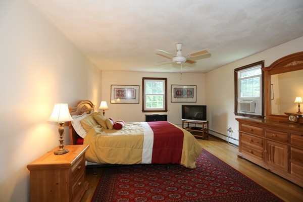88 Warren Road Sudbury, MA 01776 - Photo 10 of 16 a bed room with a bed and a tv