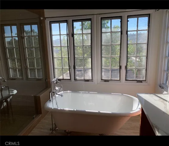 a bathroom with bathtub and window
