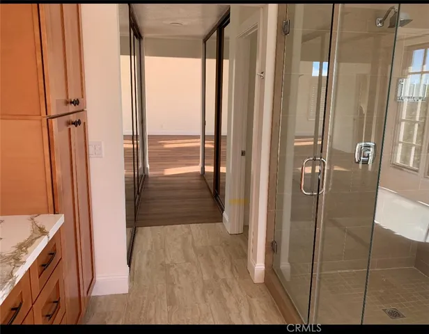 a bathroom with a shower and a sink