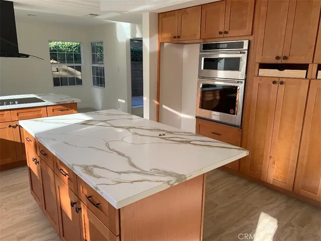 a dining room with a sink and large window