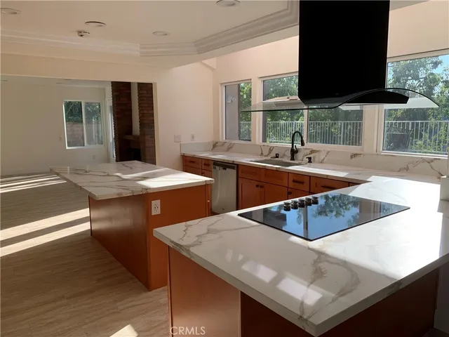 a kitchen with stainless steel appliances granite countertop a sink a stove and a microwave