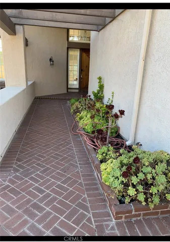a front view of a house with a yard and flowers
