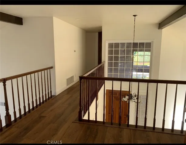 a view of staircase with railing and a window