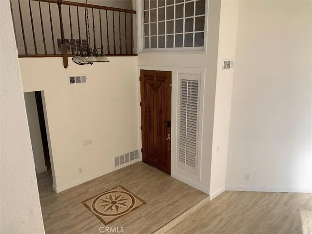 an entryway with wooden floor