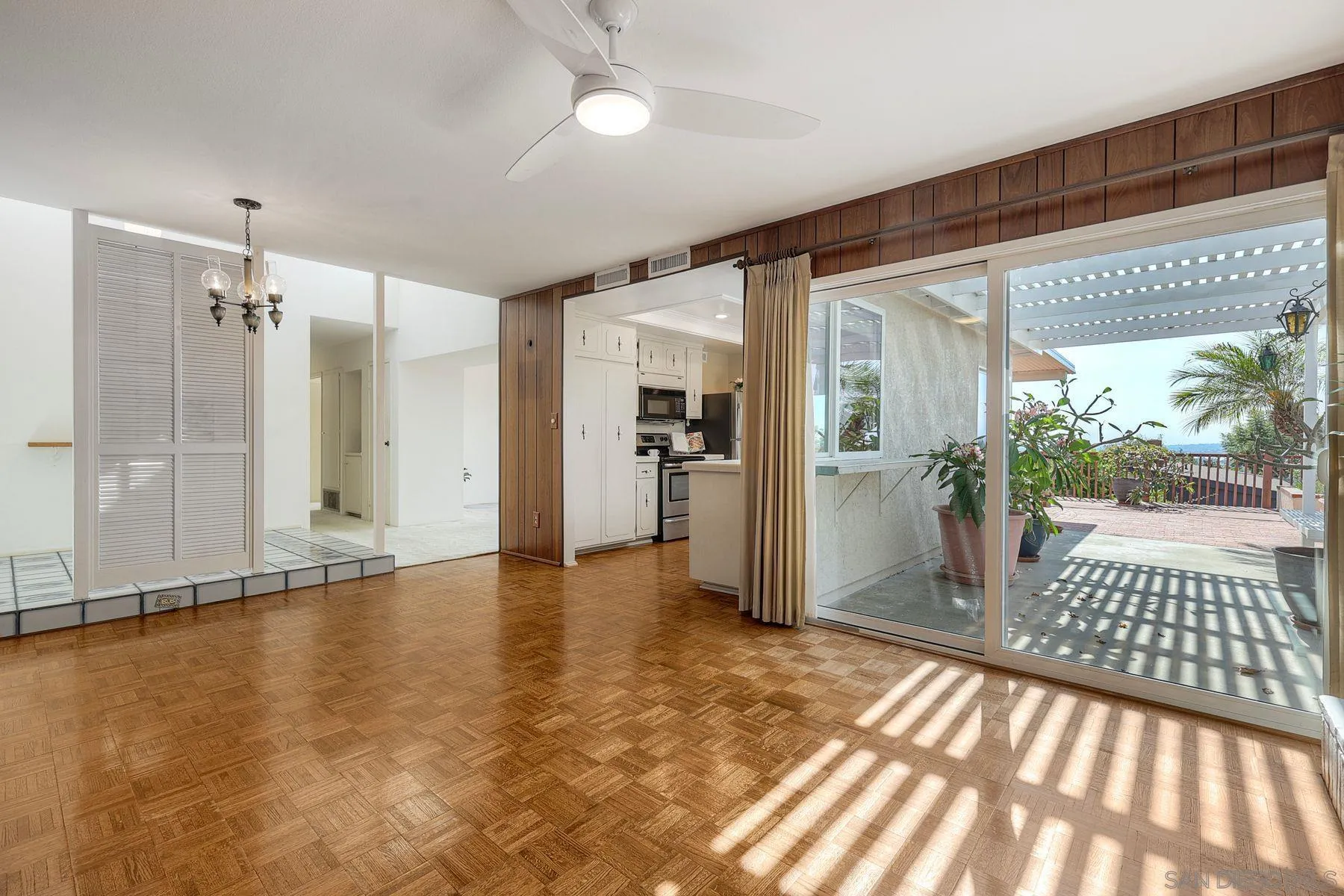 3063 Conner Way San Diego, CA 92117 - Photo 12 of 52 a view of empty room with wooden floor and windows