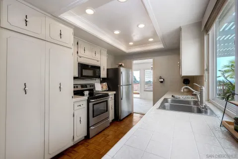 a kitchen with stainless steel appliances granite countertop a sink a stove and a refrigerator