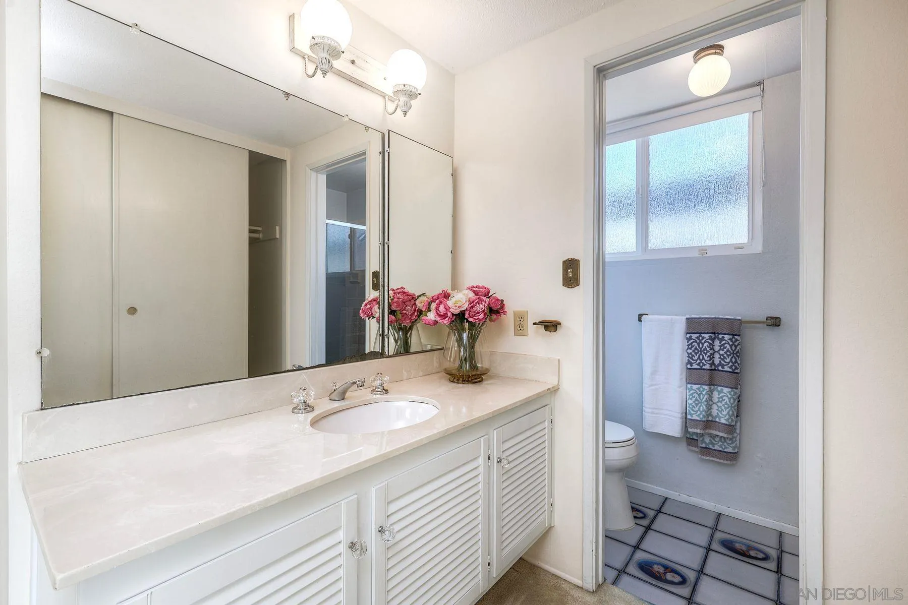 3063 Conner Way San Diego, CA 92117 - Photo 19 of 52 a bathroom with a granite countertop sink a toilet and a mirror