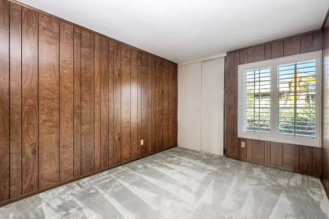a view of an empty room with wooden walls