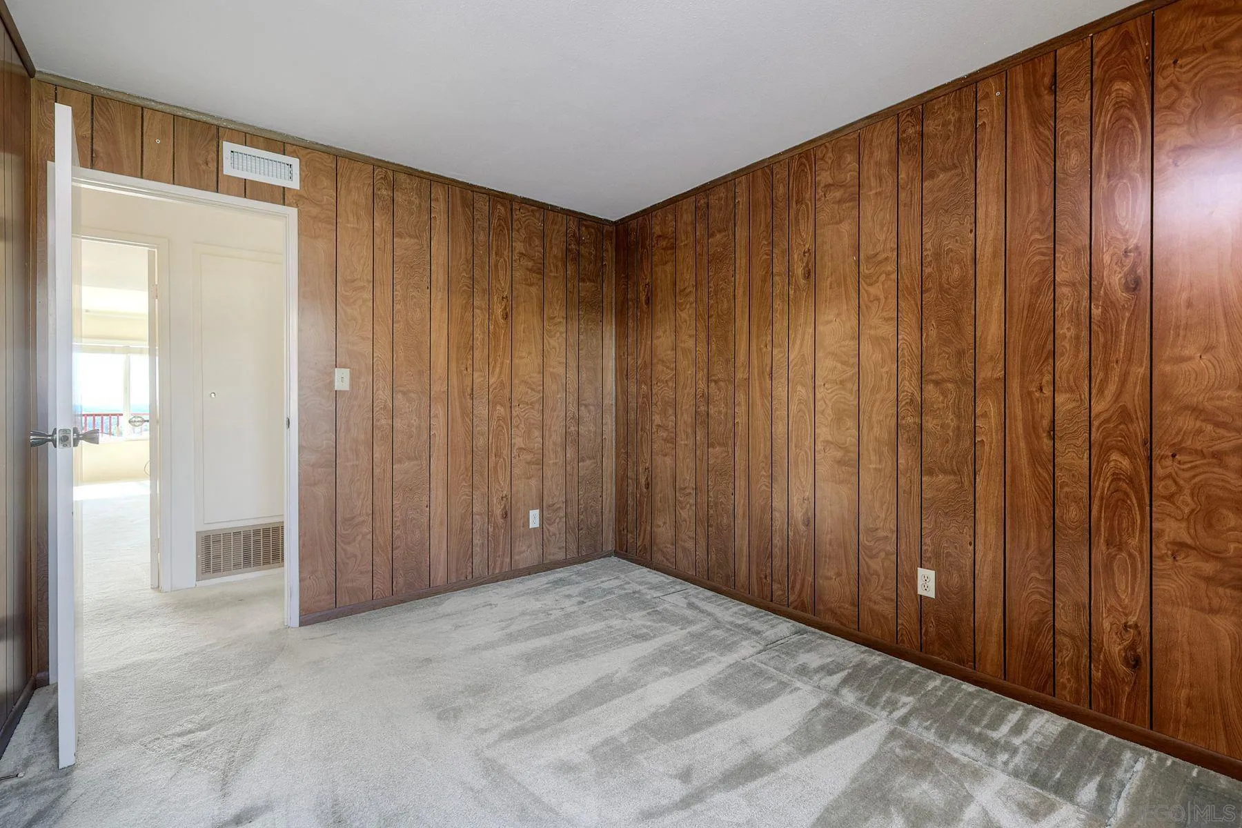 3063 Conner Way San Diego, CA 92117 - Photo 24 of 52 a view of an empty room with wooden walls