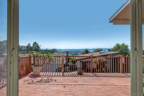 a view of a patio with a table chairs and a backyard