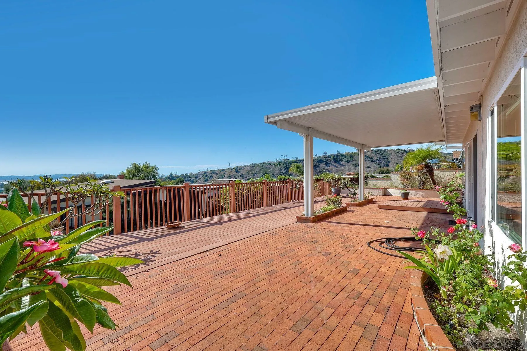 3063 Conner Way San Diego, CA 92117 - Photo 30 of 52 a view of a patio with a table chairs and a backyard