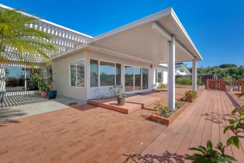a view of a house with backyard sitting area and porch