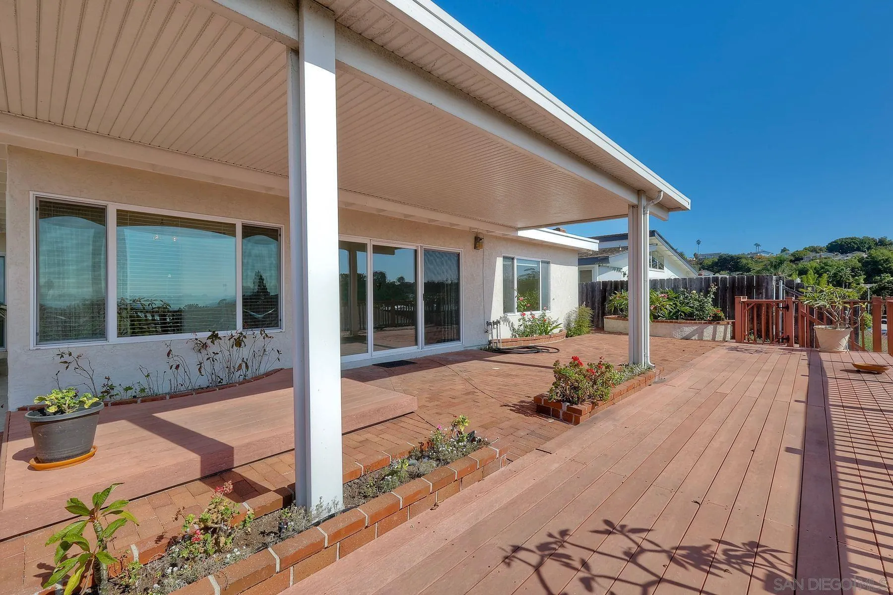 3063 Conner Way San Diego, CA 92117 - Photo 33 of 52 a view of a house with backyard sitting area and porch