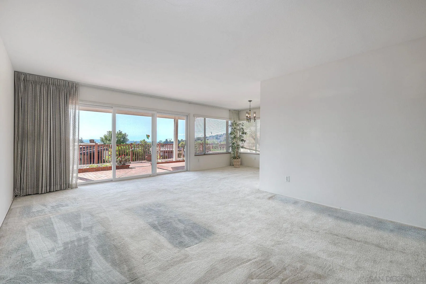 3063 Conner Way San Diego, CA 92117 - Photo 5 of 52 a view of a livingroom with furniture and floor to ceiling window