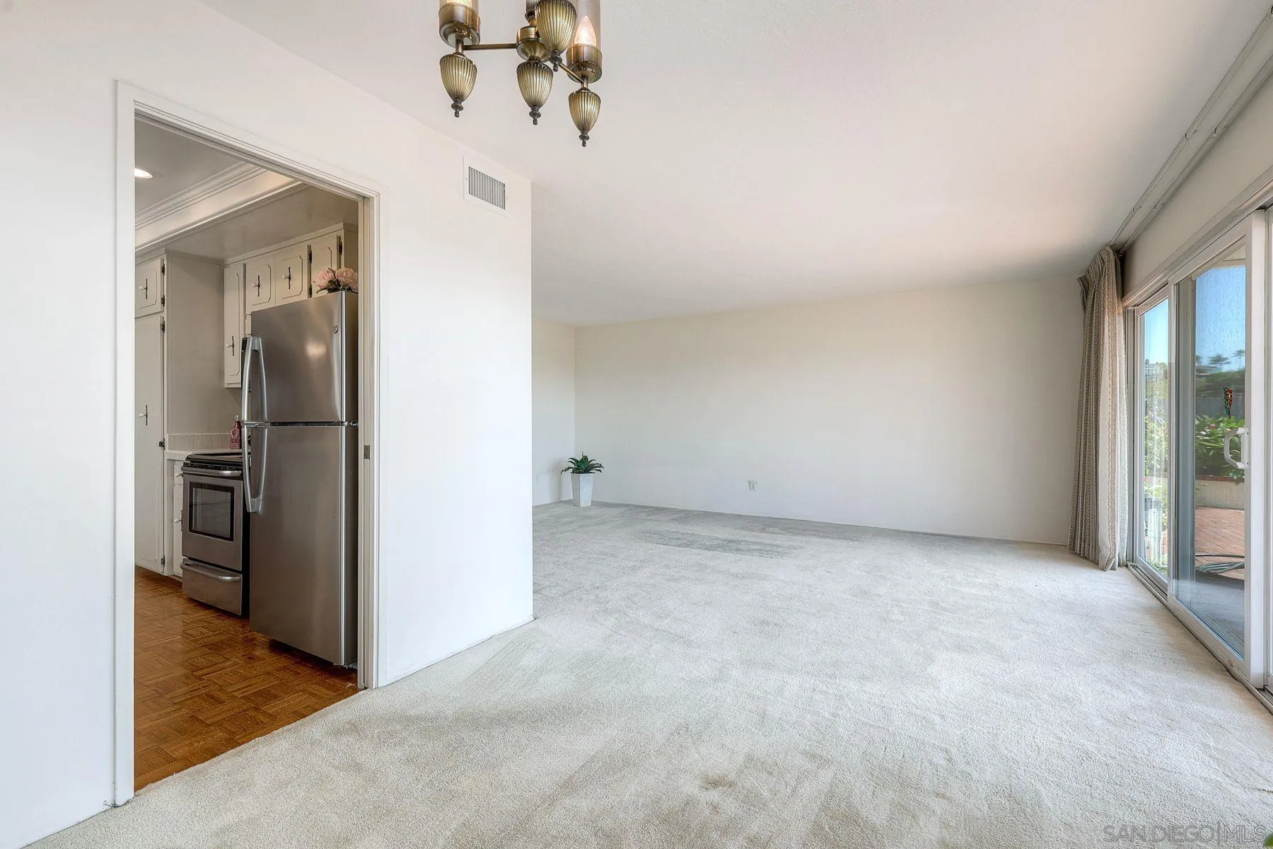 3063 Conner Way San Diego, CA 92117 - Photo 8 of 52 an empty room with a view of a kitchen