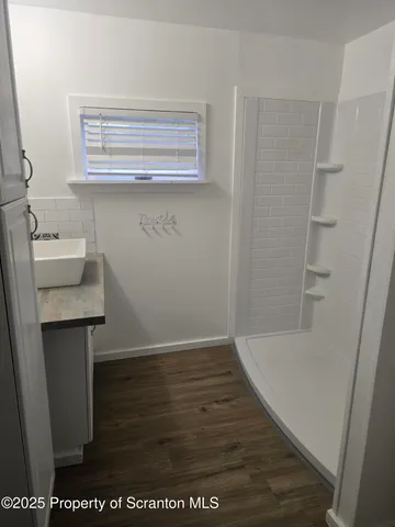 a view of storage and utility room with wooden floor