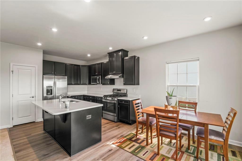 327 Crossing Drive Eighty Four, PA 15330 - Photo 12 of 34 a kitchen with stainless steel appliances granite countertop a sink a stove and a refrigerator