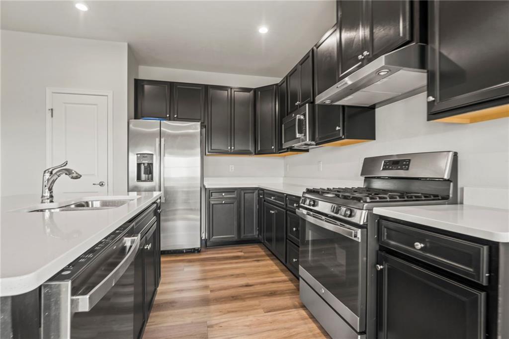 327 Crossing Drive Eighty Four, PA 15330 - Photo 16 of 34 a kitchen with stainless steel appliances granite countertop a stove and a sink