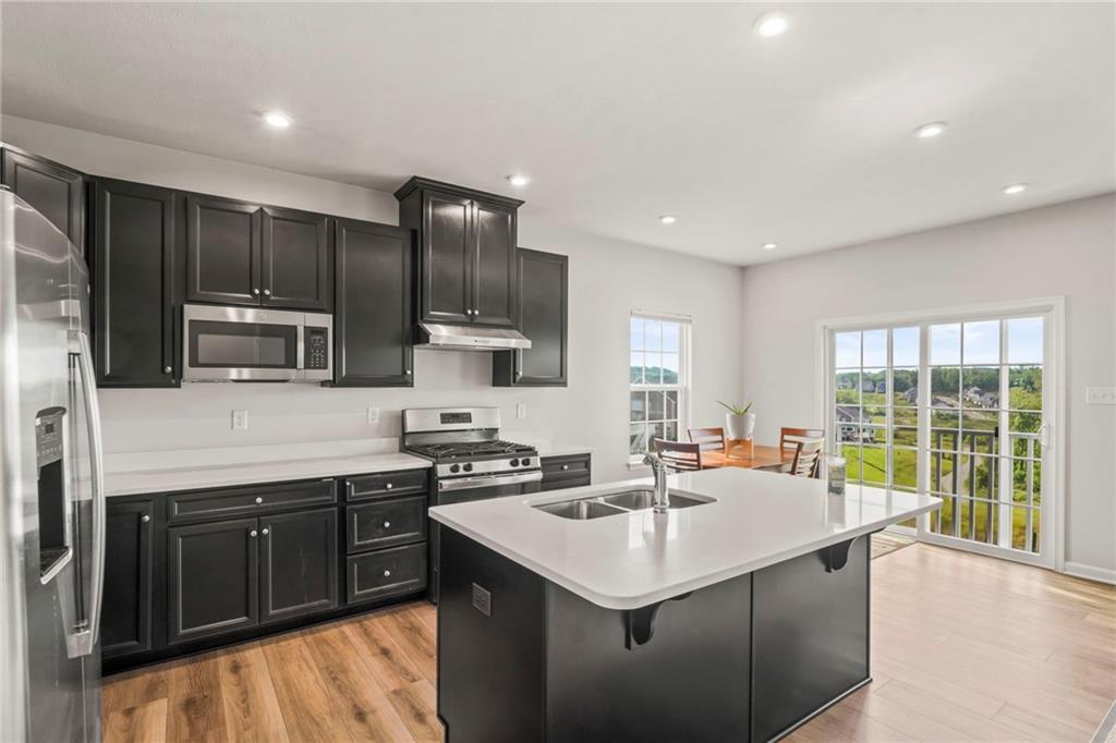 327 Crossing Drive Eighty Four, PA 15330 - Photo 17 of 34 a kitchen with a stove a sink a microwave a refrigerator and cabinets