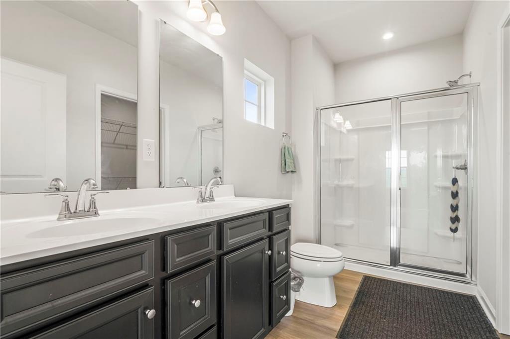 327 Crossing Drive Eighty Four, PA 15330 - Photo 20 of 34 a bathroom with a double vanity sink toilet and shower