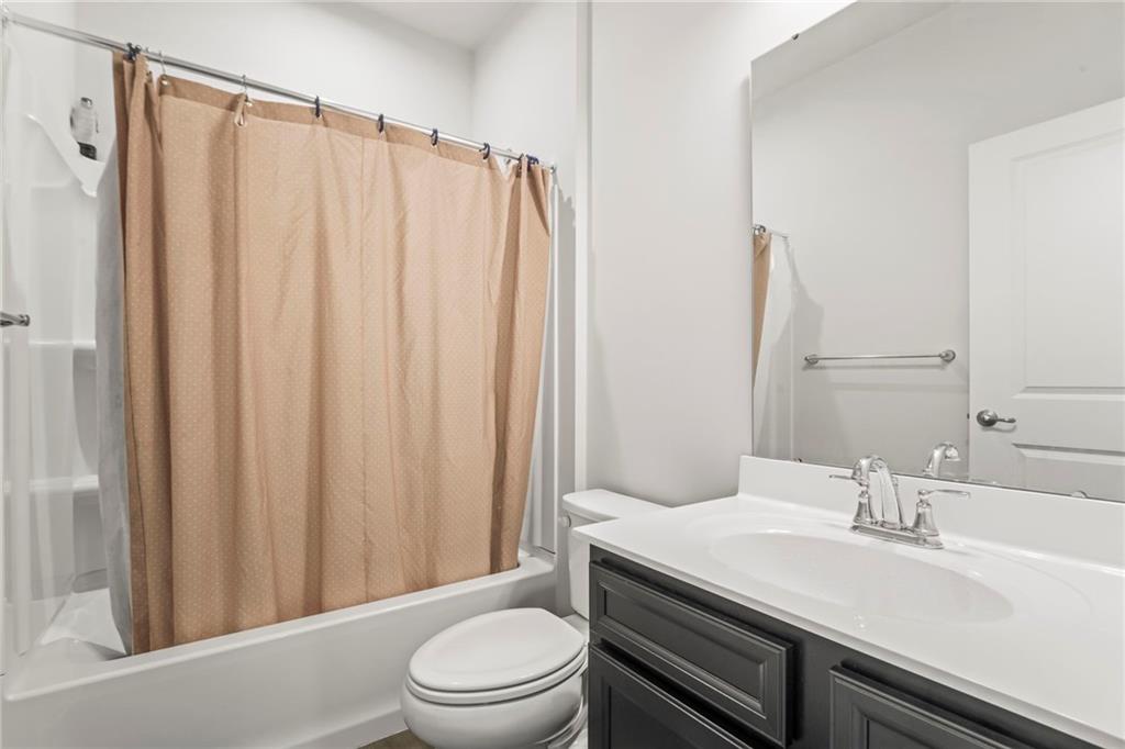327 Crossing Drive Eighty Four, PA 15330 - Photo 26 of 34 a bathroom with a sink a toilet a mirror and shower curtain