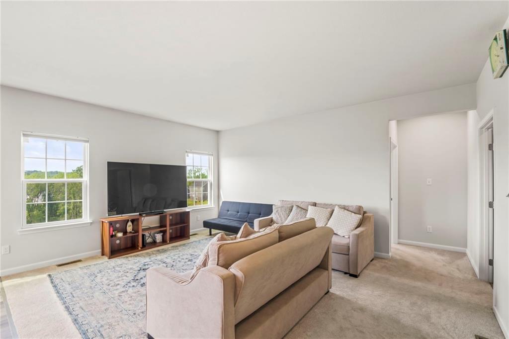 327 Crossing Drive Eighty Four, PA 15330 - Photo 9 of 34 a living room with furniture and a flat screen tv