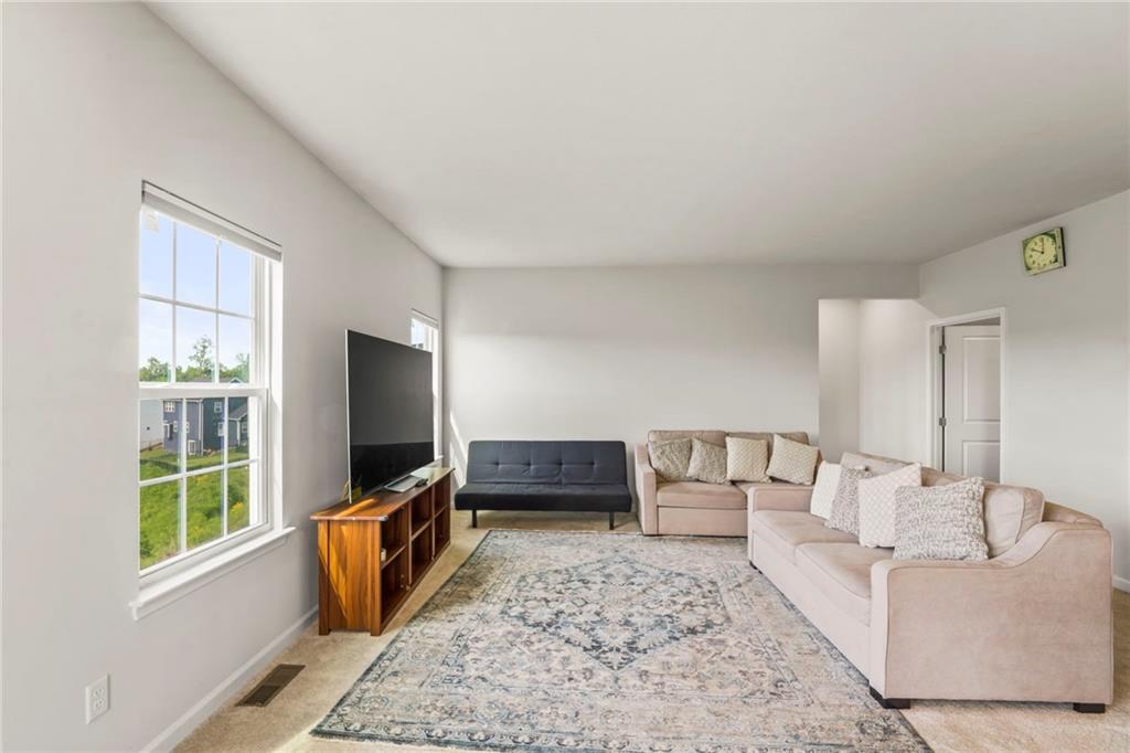 327 Crossing Drive Eighty Four, PA 15330 - Photo 10 of 34 a living room with furniture and a flat screen tv