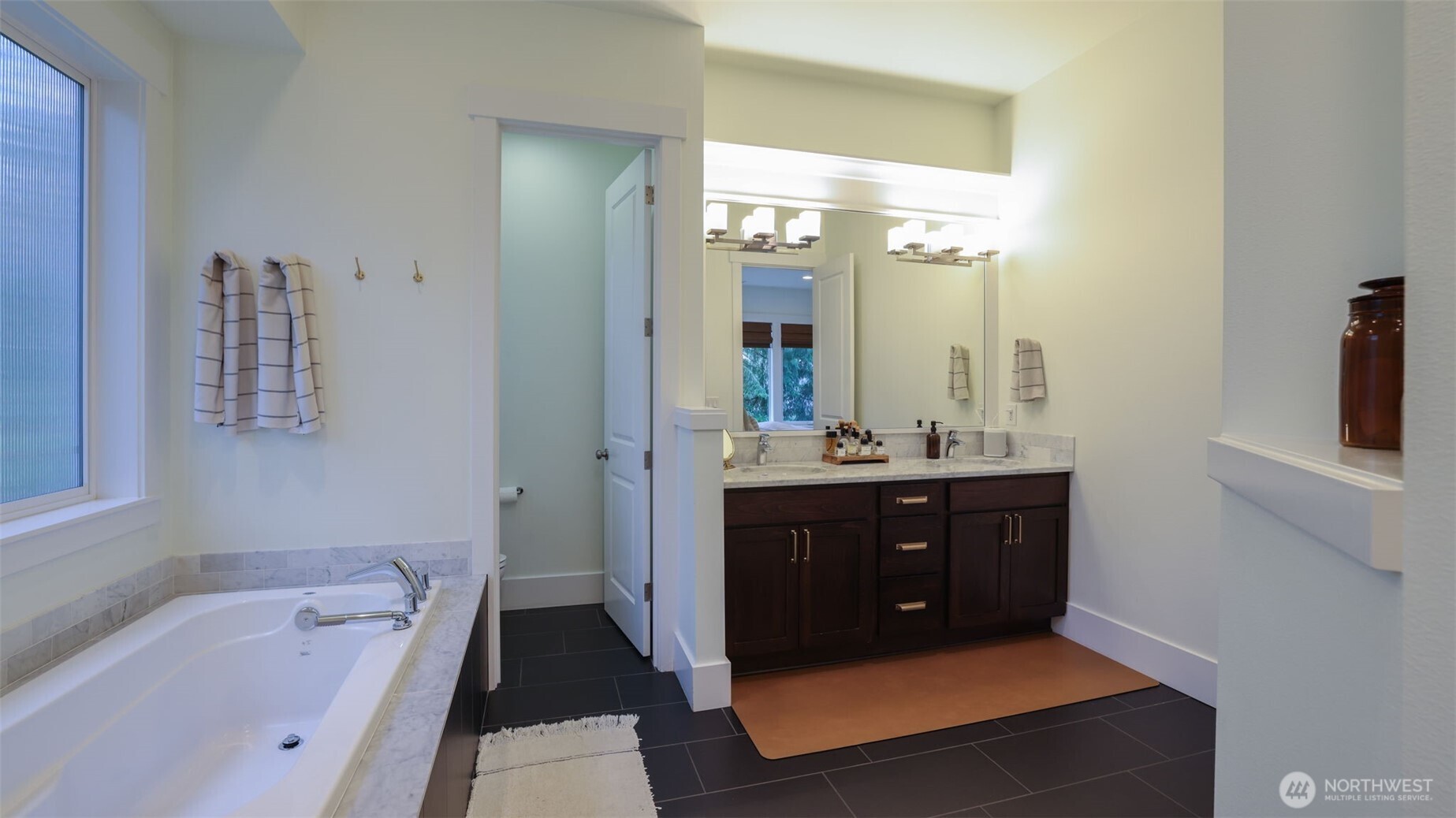 629 Field Place Northeast Renton, WA 98059 - Photo 24 of 37 a bathroom with a tub sink vanity and mirror