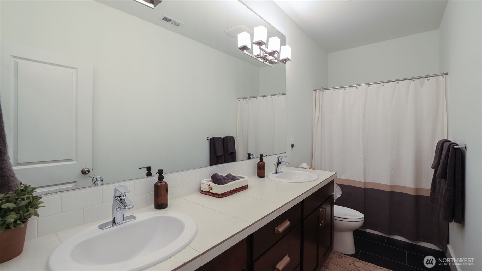 629 Field Place Northeast Renton, WA 98059 - Photo 29 of 37 a bathroom with a sink double vanity and a mirror
