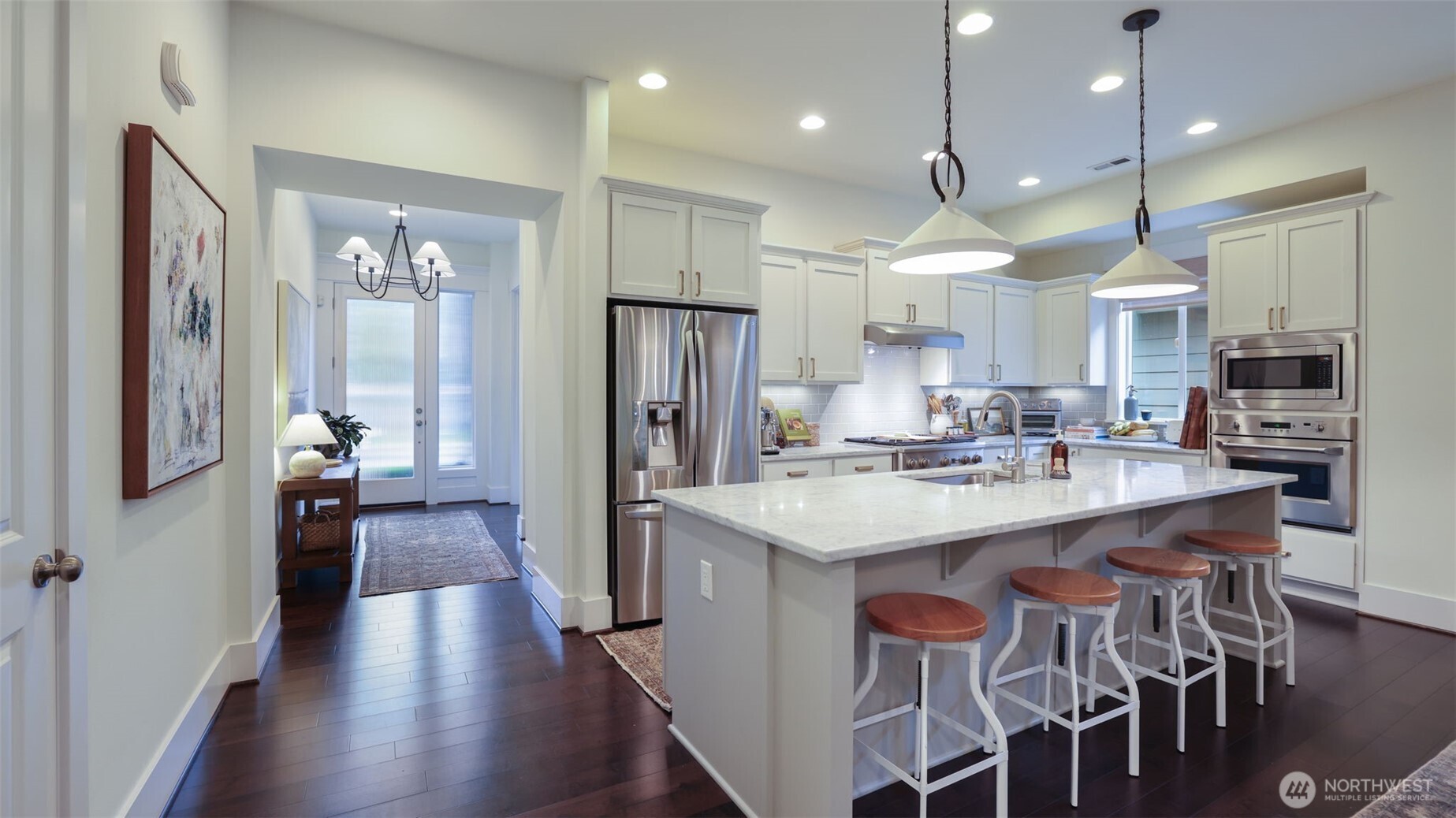 629 Field Place Northeast Renton, WA 98059 - Photo 5 of 37 a kitchen with stainless steel appliances a dining table chairs refrigerator and sink