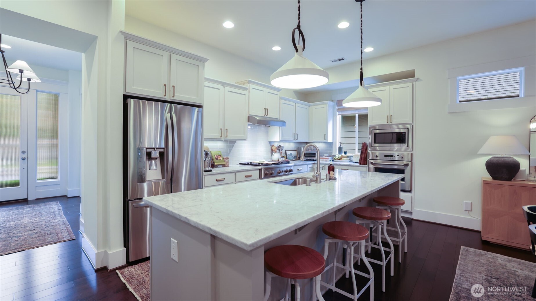 629 Field Place Northeast Renton, WA 98059 - Photo 8 of 37 a kitchen with stainless steel appliances granite countertop a refrigerator a sink a stove a dining table and chairs