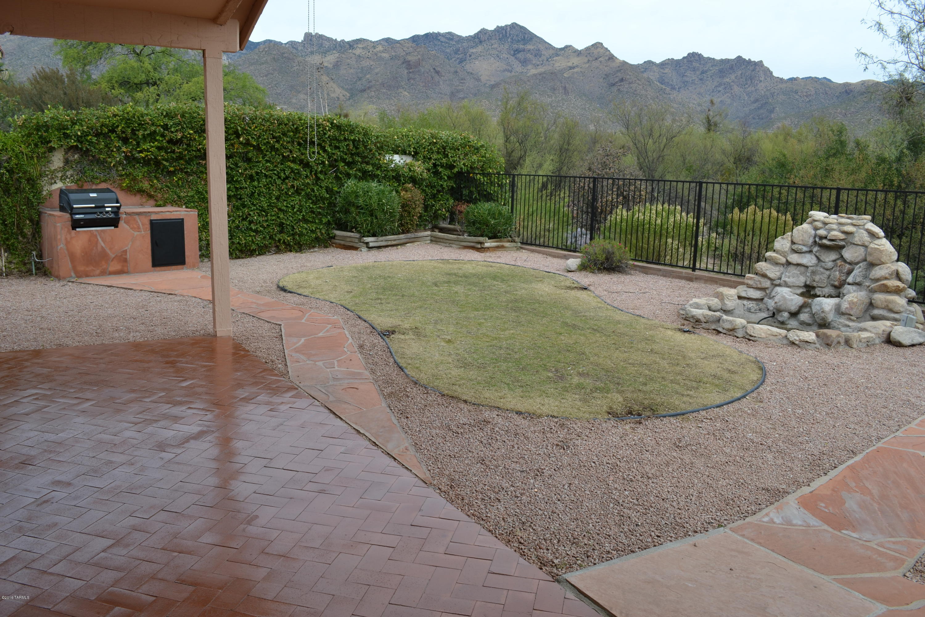 5640 North Cherokee Ridge Road Tucson, AZ 85750 - Photo 36 of 39 an aerial view of a house with a yard and a garden