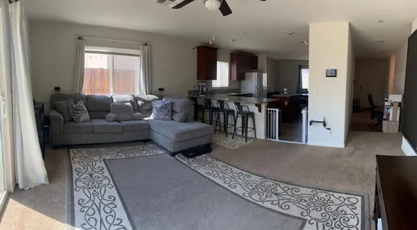 a living room with furniture and a chandelier