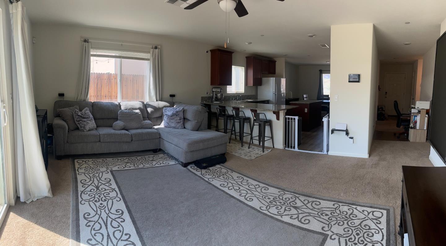 812 Riesling Lane Coalinga, CA 93210 - Photo 2 of 4 a living room with furniture and a chandelier