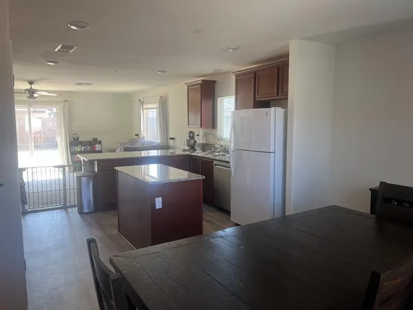 a kitchen with a refrigerator and a sink