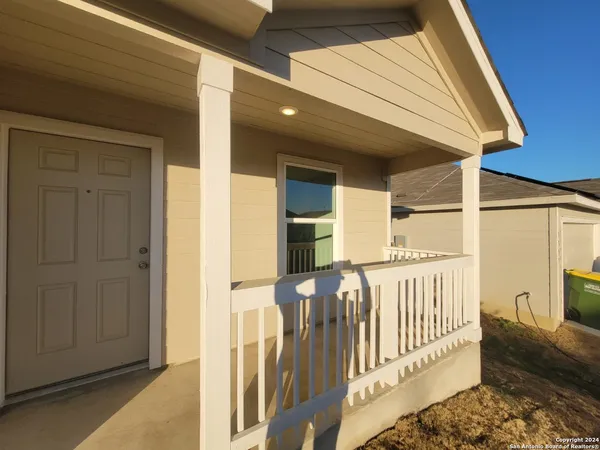 a view of a house with wooden fence