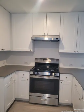 a stove top oven sitting inside of a kitchen