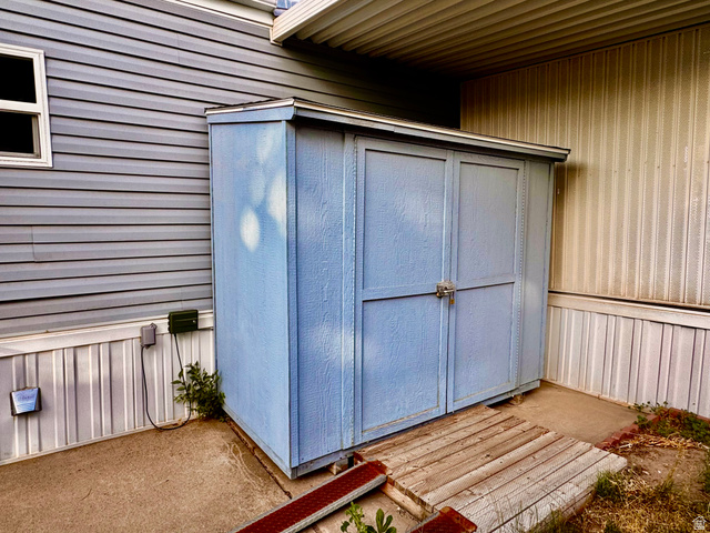 158 Cushing Way Layton, UT 84041 - Photo 14 of 14 Freestanding shed with double doors and a wood plank ramp