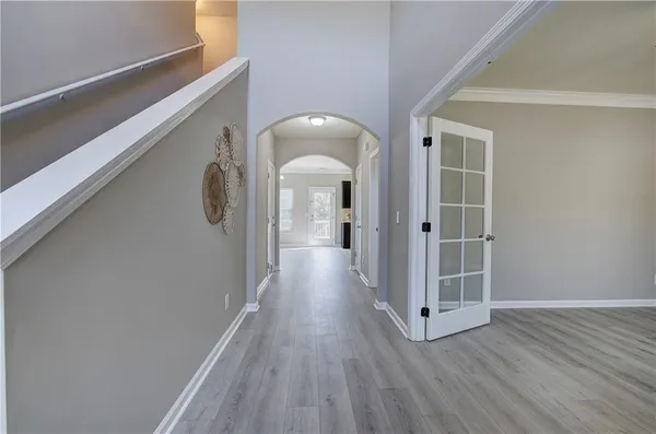 a view of a hallway with wooden floor and staircase