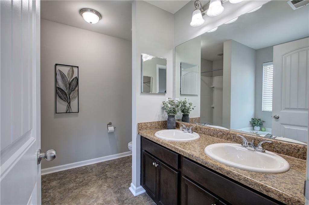 4 Timberland Trace Court Dallas, GA 30157 - Photo 28 of 53 a bathroom with a granite countertop sink and a mirror