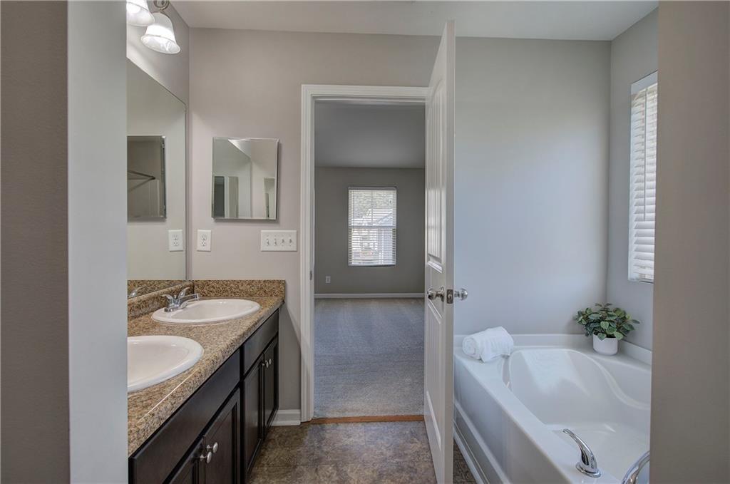 4 Timberland Trace Court Dallas, GA 30157 - Photo 30 of 53 a bathroom with a tub sink and mirror