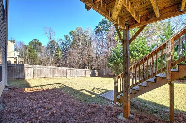 a view of a yard with swimming pool and sitting area
