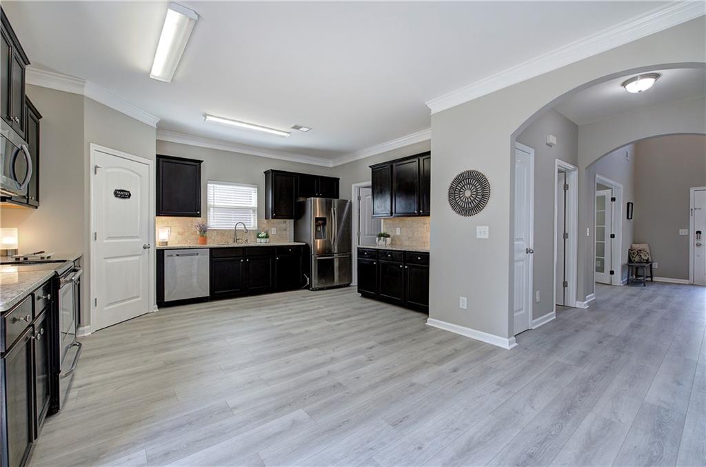 4 Timberland Trace Court Dallas, GA 30157 - Photo 5 of 53 a large kitchen with cabinets and wooden floor