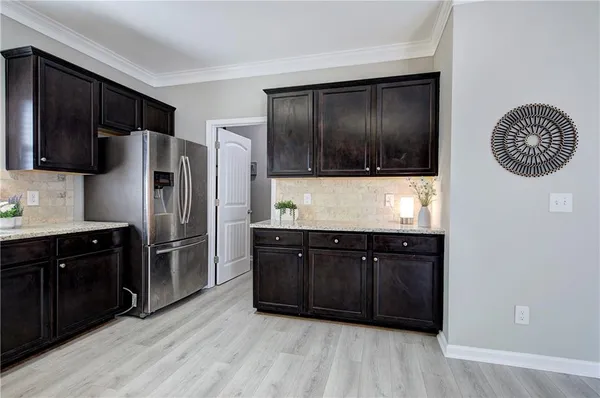 a kitchen with stainless steel appliances granite countertop a refrigerator and a sink