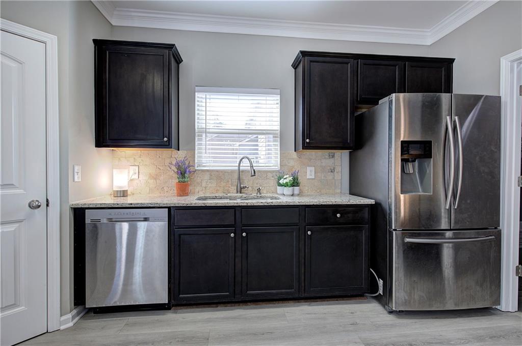 4 Timberland Trace Court Dallas, GA 30157 - Photo 7 of 53 a kitchen with granite countertop a refrigerator and a sink